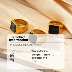 Detailed view of three 18k gold plated titanium steel rings with black enamel inlay