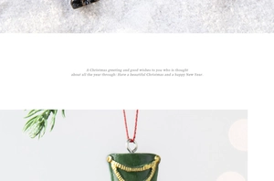 Detailed view of green nutcracker soldier hat ornament with gold chain and red string