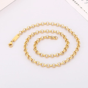 Polished gold stainless steel circle link necklace with lobster clasp on pink background