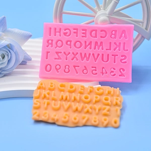 Detailed view of pink silicone alphabet and number mold with finished 3D letters