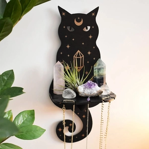 Detail of black cat wooden shelf with gold moon stars patterns and hanging hooks