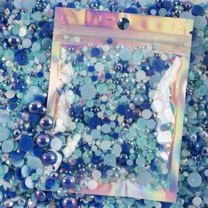 Mixed blue and white flatback resin pearls and rhinestones in laser packaging bag