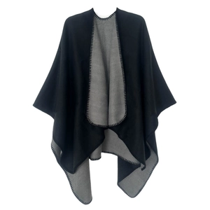 Detail view of double-sided black and grey poncho with contrast blanket stitch edging
