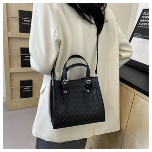 Elegant black woven leather tote bag for women with dual handles and shoulder strap