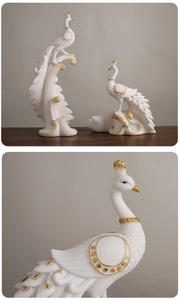 Detailed macro view of matte white peacock statues with gold trim for home decor