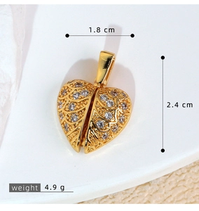 Macro detail of a golden heart locket with pavé zircon wings and vintage carvings
