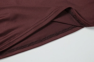 Vue macro des doubles coutures sur l'ourlet de la robe plissée bordeaux foncé