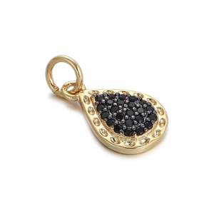 Detail showing a gold-plated teardrop pendant with micro-pave black gemstones and eyelet