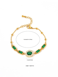 Detail view of gold vintage bracelet with green stones and lobster clasp sizing info