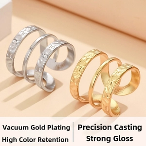 Detail of layered adjustable stainless steel rings with gold and silver hammered texture