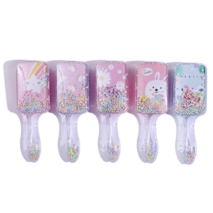 Detail of cute cartoon printed hair brushes with colorful shaking foam balls inside
