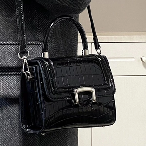 Elegant black crocodile embossed leather handbag with silver hardware and shoulder strap