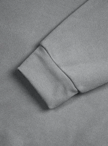 Close-up detail of grey ribbed cuffs on men's vintage half-zip sweatshirt fabric