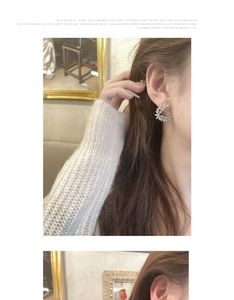 Close-up of elegant crescent wheat-ear earrings with zircons worn by a model