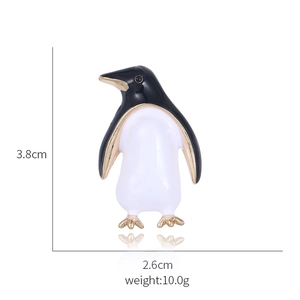 Detail view of cartoon penguin brooch with dimensions 3.8cm height and 2.6cm width