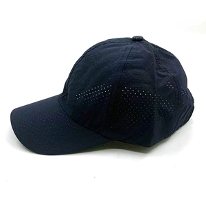 Détail des perforations laser sur une casquette de baseball bleu marine séchage rapide