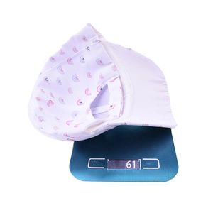 Detailed weight display of white rainbow print baseball cap on digital scale at 61g
