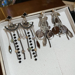 Detail shot of vintage long tassel earrings with black rhinestones and bohemian beads
