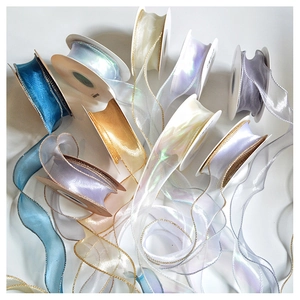 Close-up of assorted champagne and metallic sheer organza ribbons with wired edges