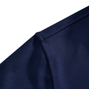 Detailed close-up of navy blue polo shirt mesh fabric and fine double-needle stitching