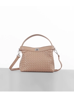 Detailed view of apricot woven leather handbag with silver turn-lock and crossbody strap