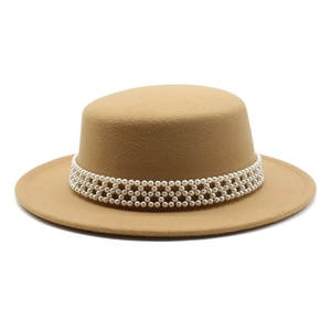 Detail of white pearl headband on camel wool boater hat with flat top and wide brim