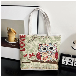 Detail of canvas tote bag featuring ethnic owl embroidery and Love You text