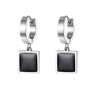 Detailed macro view of silver stainless steel hoop earrings with black square pendants