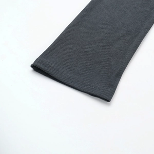 Detailed macro view of dark grey ribbed knit fabric showing stitching and texture