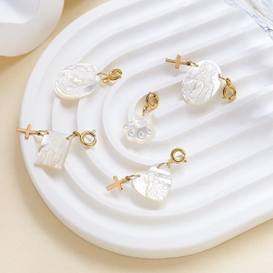 White mother of pearl shell heart and cross pendants with gold plated clasps for jewelry