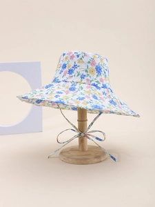 Detail of floral wide-brim sun hat with adjustable wind strap and pastel flower patterns