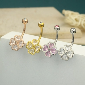Elegant four-leaf clover belly rings with zirconia stones in rose gold, gold, and silver finishes