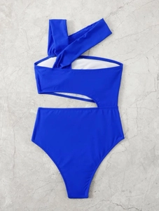 Close-up of royal blue one-shoulder cutout swimsuit with high waist on marble background