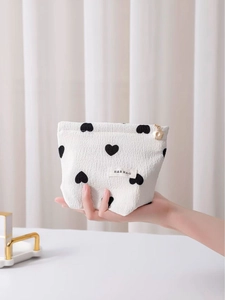Handheld heart pattern waffle makeup bag with gold floral zipper for cosmetic storage