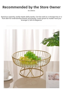 Golden metal hollow fruit basket with white marble base shown holding fresh green grapes