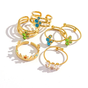Set of 7 gold-plated stainless steel rings with colorful zircons in various designs