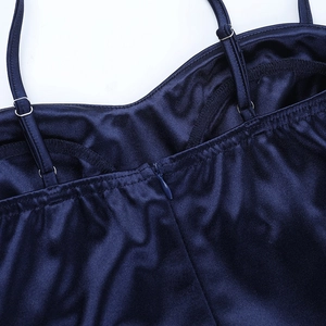 Close-up of invisible zipper and fine stitching on a dark blue satin evening dress