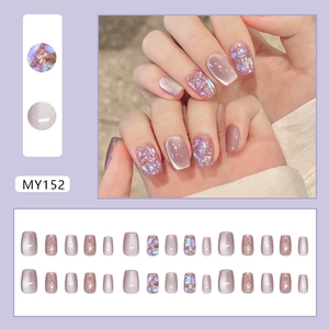 Cat eye lilac press-on nails set with glitter and shell flakes for a manicured look