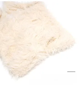 Detail shot of the plush beige faux fur texture on a warm winter trapper hat