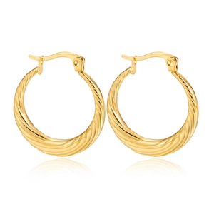 Close-up of golden hoop earrings featuring a twisted texture and elegant metallic luster
