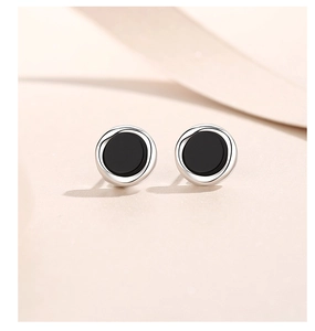 Macro shot of minimalist S925 sterling silver studs with round black onyx inlay