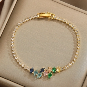 Macro view of gold-plated tennis bracelet featuring colorful marquise-cut rhinestones