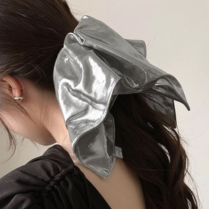 Metallic silver oversized bow hair scrunchie accessory for elegant high ponytails