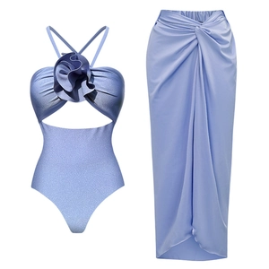 Detail of light blue shimmering swimsuit set with 3D flower and matching long wrap skirt