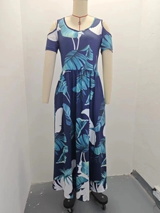 Detailed view of the dark blue tropical leaf print and cold shoulder sleeve design