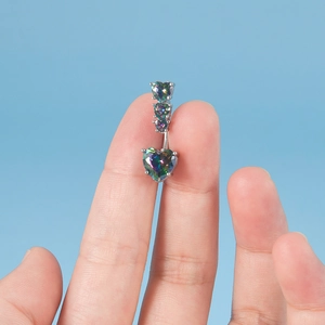 Surgical steel belly button ring featuring iridescent heart-shaped cubic zirconia stones