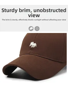 Detail of a brown cotton baseball cap with a deer embroidery and a stiff curved brim