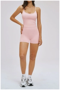 Pink two-piece yoga set featuring slim fit tank top and high-waist sports shorts with socks