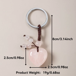 Macro detail of natural rose quartz heart keychain with brown woven cord and dimensions