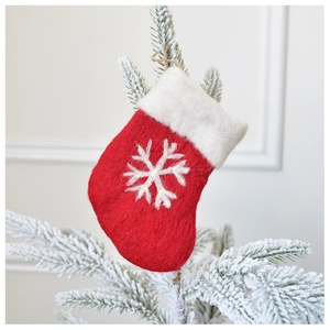 Close-up of red and white wool felt Christmas stocking ornament with snowflake embroidery